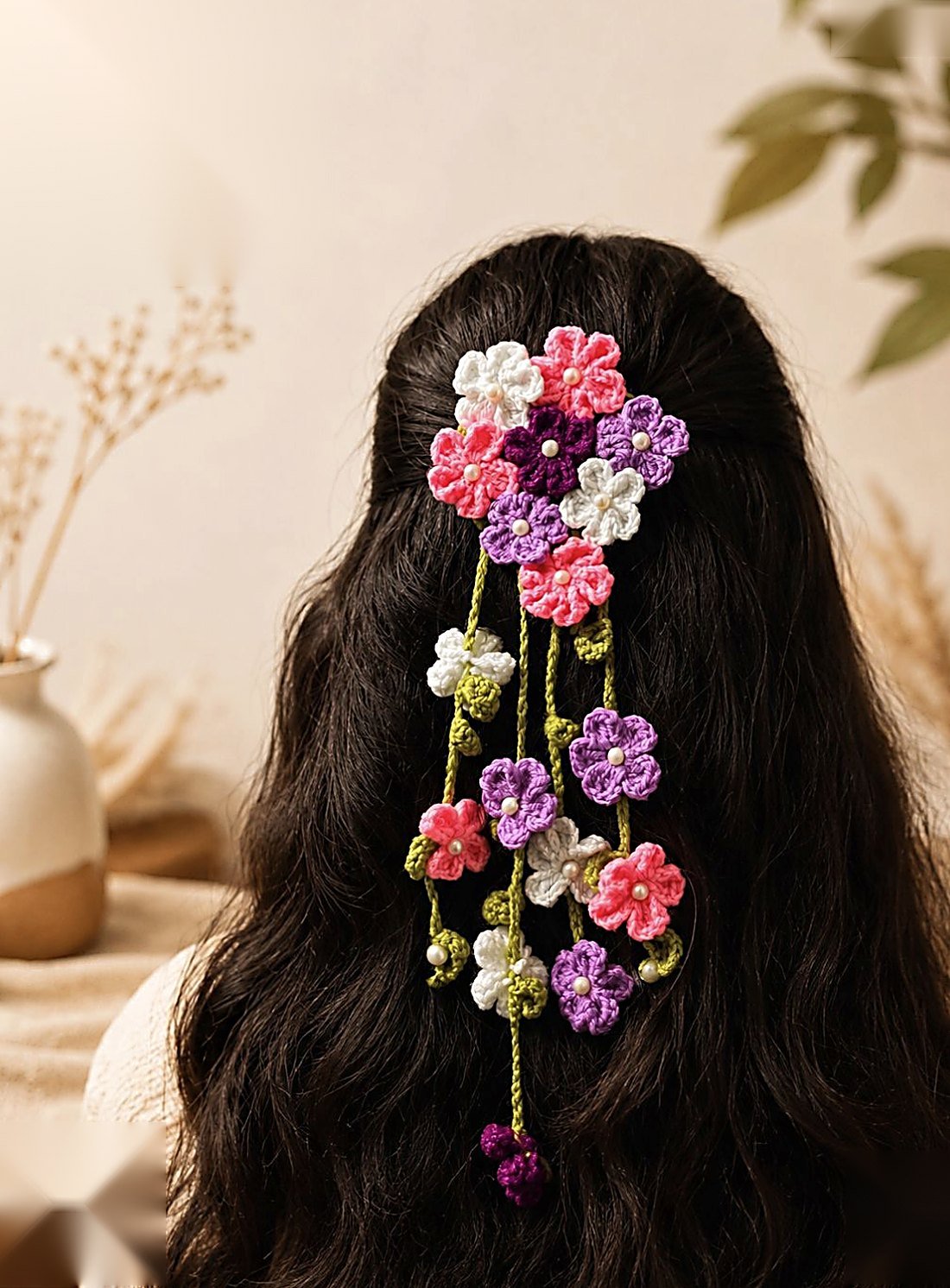 A cascade of hand-crocheted flowers pinned into long hair