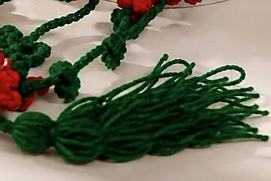 Green wool tassel close-up