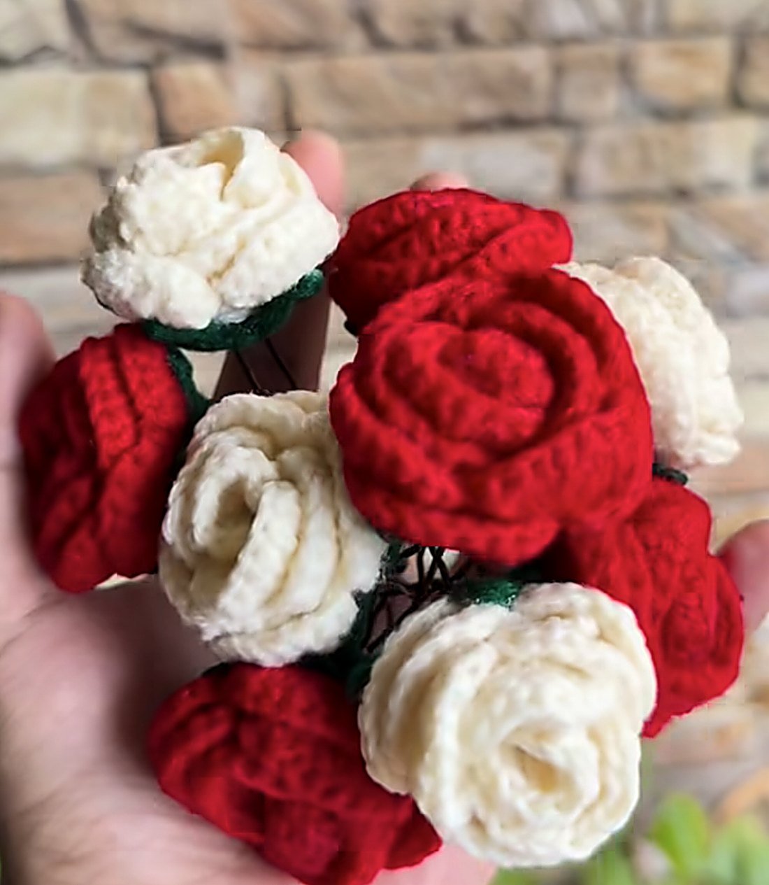 Crochet roses held in a hand